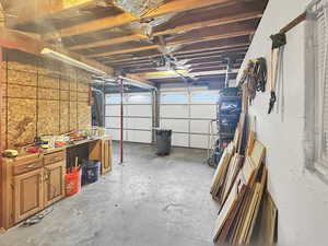 Garage featuring workshop & storage