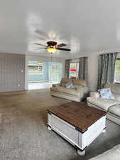 Living room with a wealth of natural light, ceiling fan,fireplace