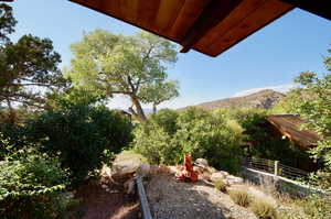 View of yard with a mountain view and fence