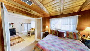 Tiled bedroom featuring beamed ceiling, visible vents, wooden ceiling, and wood walls