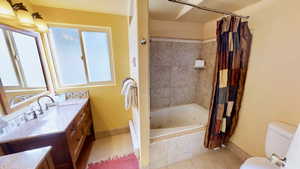 Bathroom with baseboards, a healthy amount of sunlight, tile patterned flooring, and vanity