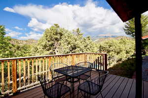 Deck featuring outdoor dining space and a mountain view