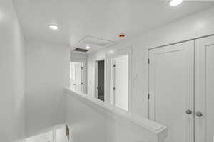 Hall with attic access and recessed lighting
