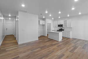 Kitchen with baseboards, stainless steel appliances, and a sink