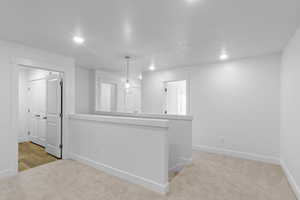Loft featuring recessed lighting, light carpet, and baseboards