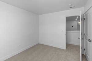 Bedroom with visible vents, carpet floors, and baseboards