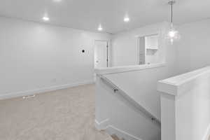 Interior space featuring recessed lighting, carpet flooring, baseboards, and visible vents