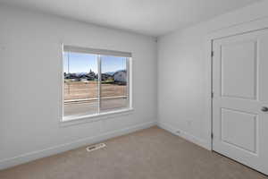 Bedroom with visible vents and baseboards