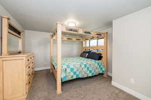 Carpeted bedroom featuring baseboards