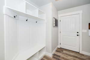 Mudroom featuring baseboards and wood finished floors