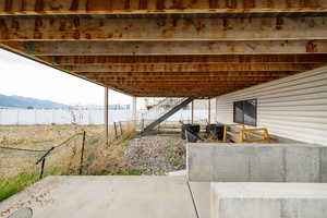 View of patio with fence, stairs, and a mountain view
