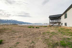 View of yard featuring a mountain view, stairway, and fence