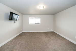 Spare room featuring baseboards, visible vents, and carpet flooring