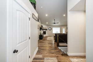 Corridor featuring baseboards, recessed lighting, wood finished floors, and visible vents