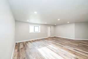 Spare room with wood finished floors, recessed lighting, and baseboards