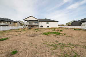 Back of house with stairway and fence