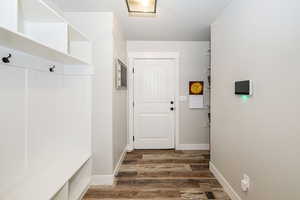 Mudroom featuring visible vents, wood finished floors, and baseboards