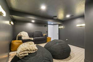 Home theater featuring recessed lighting, a textured ceiling, and visible vents