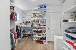 Walk in closet featuring wood finished floors