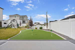 View of home's community with a fenced backyard, a yard, a residential view, and a playground