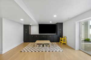 Cinema room featuring baseboards, recessed lighting, visible vents, and light wood-style floors