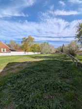 View of yard featuring fence