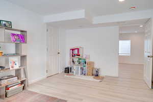 Game room with wood finished floors, baseboards, and recessed lighting