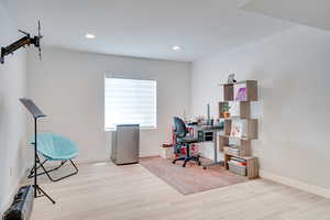 Office featuring wood finished floors, recessed lighting, and baseboards