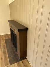 Details featuring visible vents, wood finished floors, and baseboards