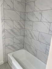 Full bathroom with a tub to relax in