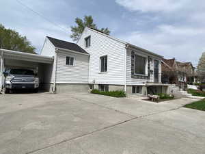 View of home's exterior featuring a carport and concrete driveway