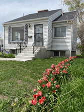 Bungalow-style home with a front lawn