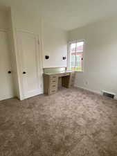 Unfurnished office with visible vents and carpet floors