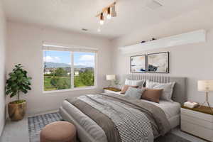Carpeted bedroom featuring a mountain view, visible vents, and baseboards