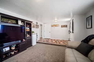 Carpeted living area with baseboards