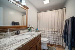 Bathroom with tile patterned floors, toilet, and vanity