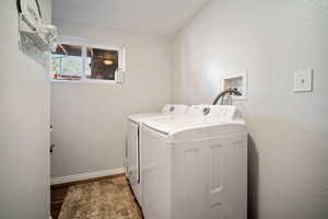 Laundry room featuring washing machine and clothes dryer, wood finished floors, laundry area, and baseboards
