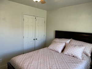 Bedroom with a ceiling fan and a closet