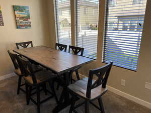 Carpeted dining area featuring baseboards