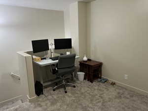 Home office featuring baseboards and carpet