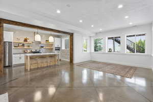 Interior space with baseboards and recessed lighting