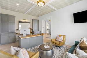 Living area with baseboards, light wood-type flooring, and wallpapered walls