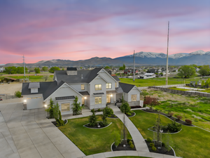 View of front facade featuring driveway, a standing seam roof, metal roof, and a mountain view