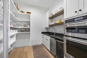 Storage area featuring a sink and beverage cooler