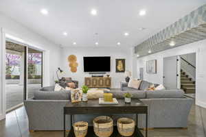 Living area featuring recessed lighting and stairs