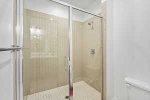 Bathroom with toilet and a stall shower