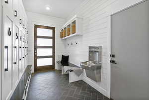 Mudroom with recessed lighting and wooden walls