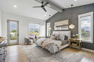 Bedroom with lofted ceiling with beams, baseboards, wallpapered walls, and access to outside
