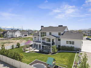 Rear view of property featuring a residential view, a fenced backyard, and a chimney