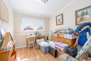 Interior space featuring ornamental molding, wood finished floors, and baseboards